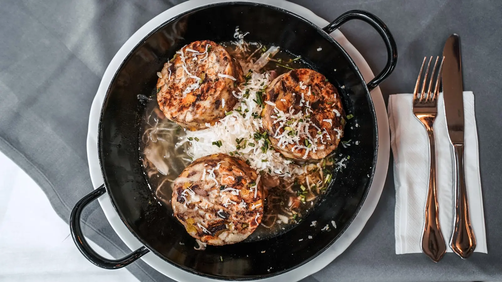 Knödel mit geriebenem Käse in einer Pfanne aus der Küche des Restaurant Musil.